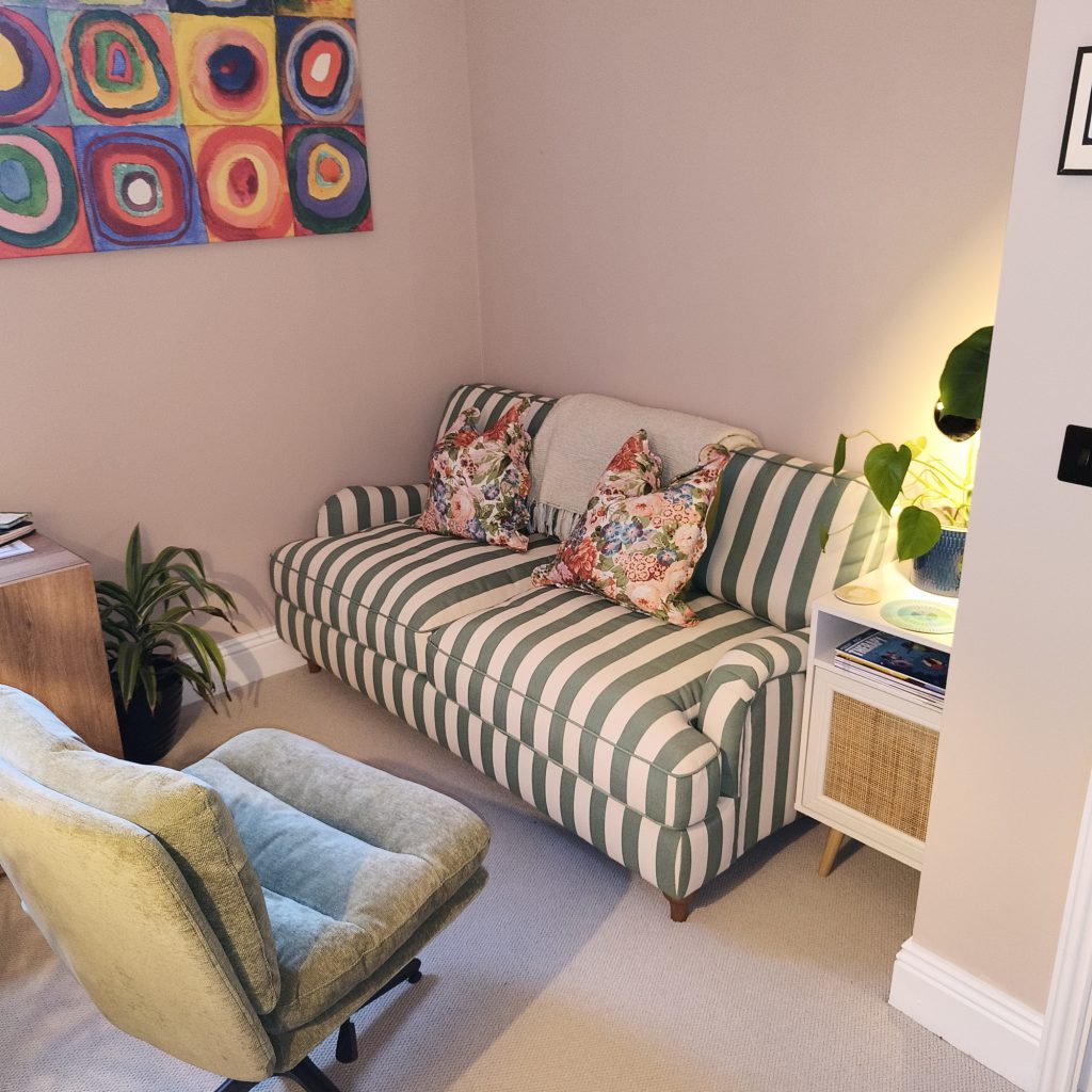The in-person therapy room in Walthamstow, with a striped sofa and armchair